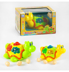 Музичний динозаврик TK 50633 (48/2) "TK Group", 2 кольори, ОЗВУЧУВАННЯ УКРАЇНСЬКОЮ МОВОЮ, світло, колесо вільного руху, пісня, яйця, в коробці